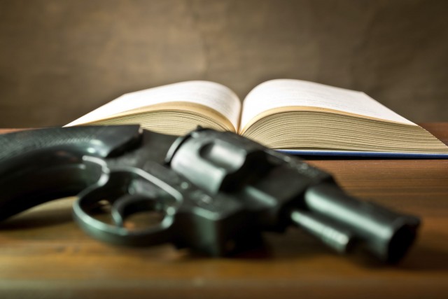 open book with handgun