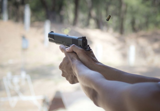 Man firing pistol at firing range